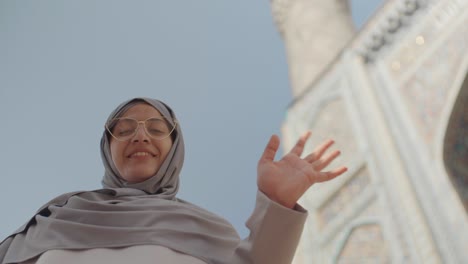 portrait of mixed-race woman near mosque
