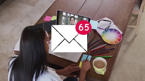 Animation-of-email-icon-with-numbers-over-caucasian-woman-on-laptop-video-call