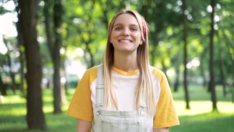 beautiful young woman looking at camera and laughing outdoors