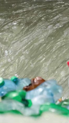 ranger pick up water into the plastic bottle from the river at the jungle closeup ranger pick up water into the plastic bottle from the river at the jungle closeup
