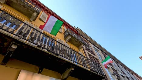 italian flag waving on a balcony in piedmont