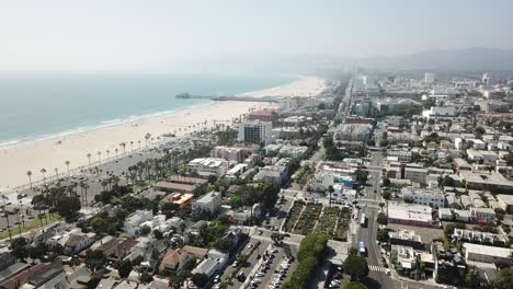flying drone backwards revealing the venice and santa monica beach line