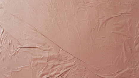 video of close up of beige creased fabric with copy space