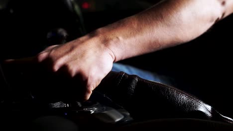 person shifting gears in a car