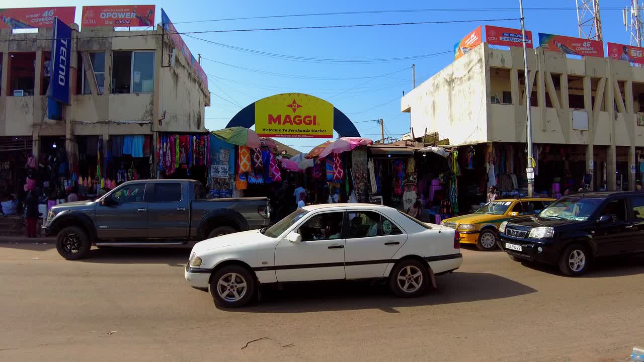 Tilt-up view of Serekunda Market main entrance during busy day time