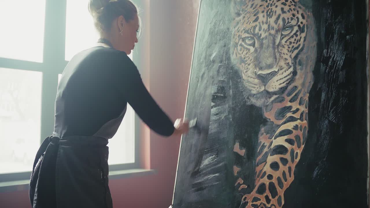Woman Artist Painting a Leopard Portrait in a Studio