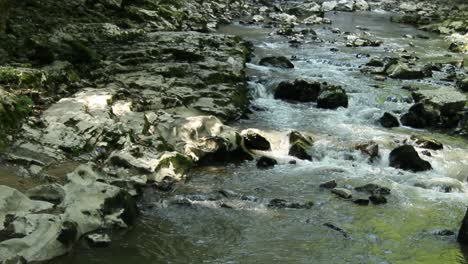 close up of flowing clean water through the rocks