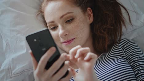 Top-view-of-young-woman-browsing-a-phone