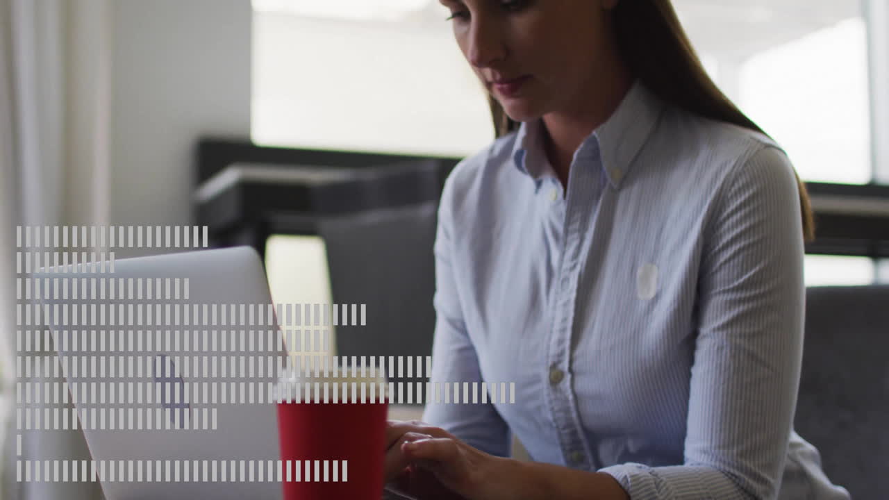 Businesswoman working on laptop with data processing animation over screen