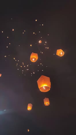 tourist floating sky lanterns in loy krathong festival , chiang mai ,thailand