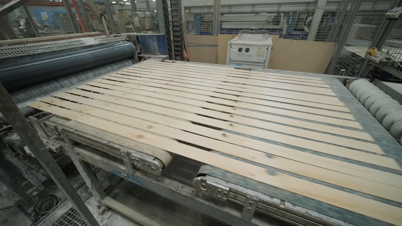 Wooden Slats Moving Along a Conveyor Belt in a Factory