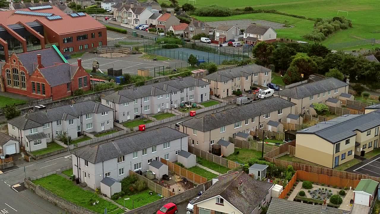 Aerial view looking down across Welsh primary school and Holyhead town housing suburb