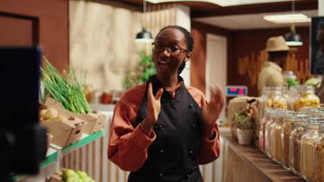 African-american-vendor-presenting-variety-of-pasta-in-jars