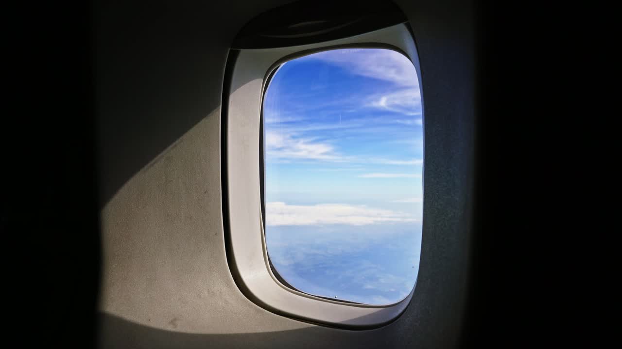 Looking through the porthole of a passenger airliner
