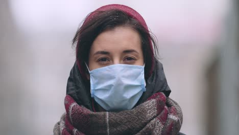 woman in winter city wearing mask