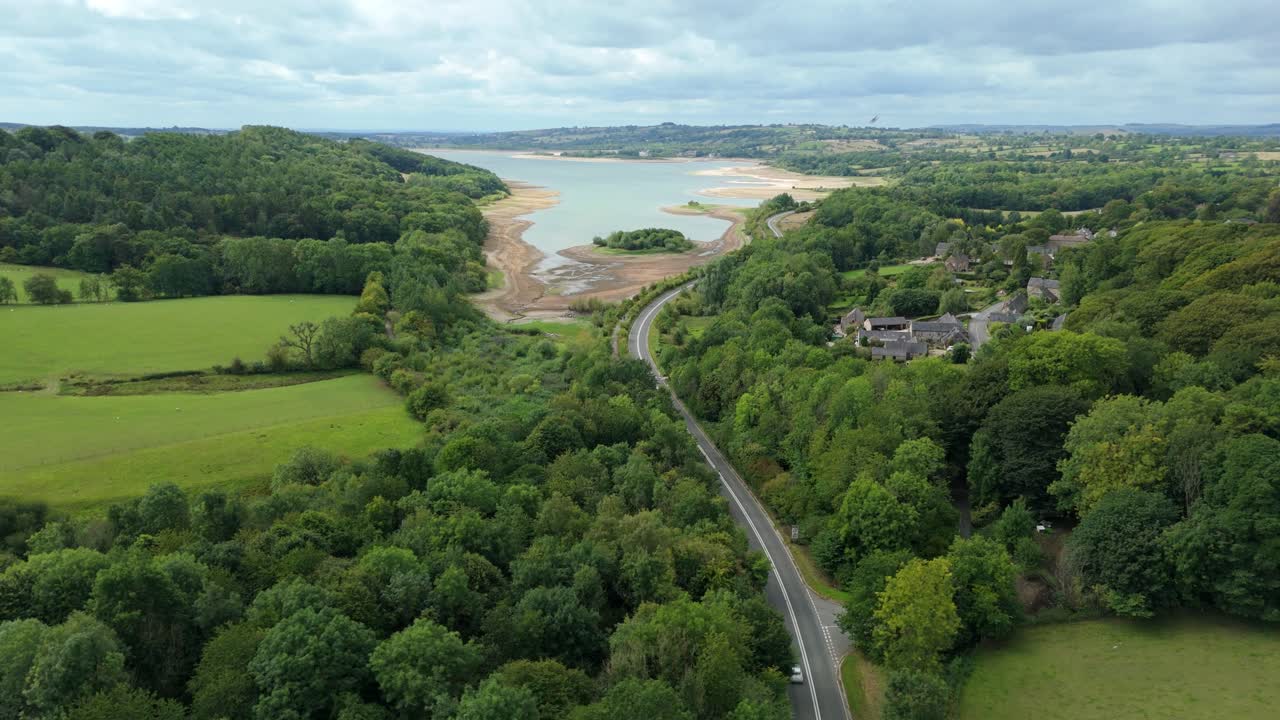 Scenic aerial view of Carsington Water reservoir with green landscape and roads in Derbyshire Dales United Kingdom