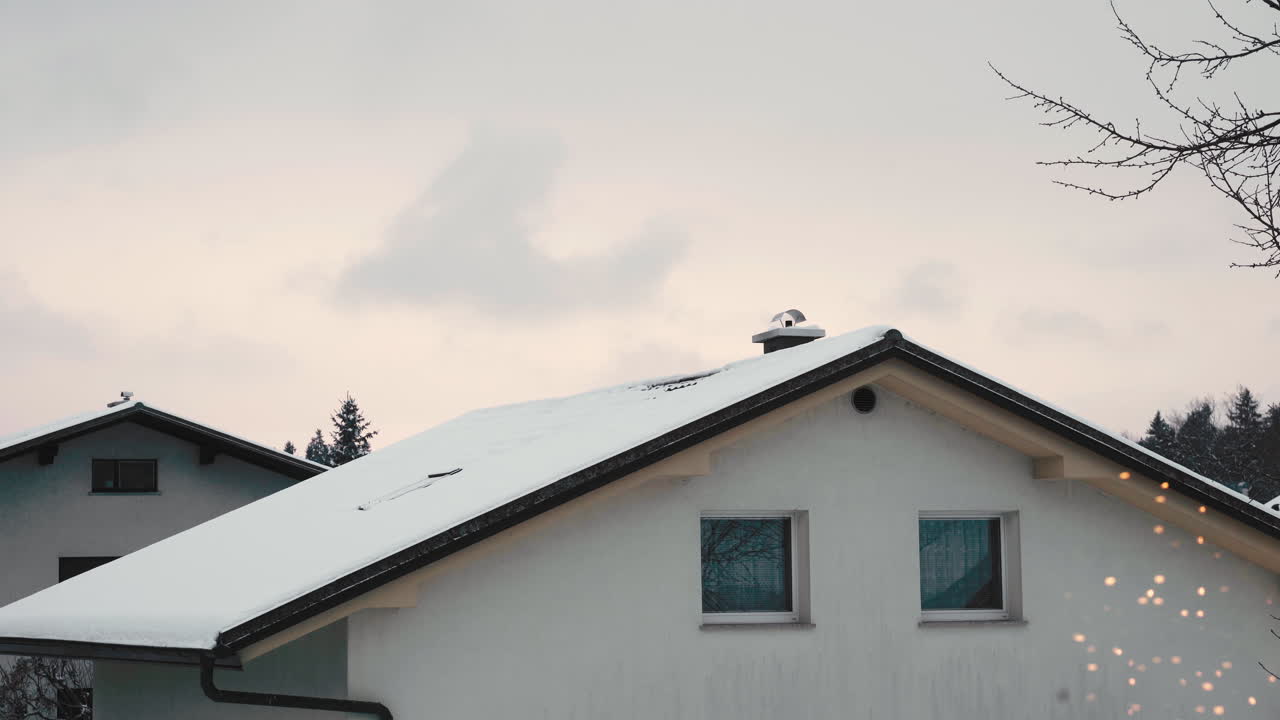 A snowed in home burning fuel, smoking through chimney