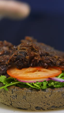 delicious pulled beef sandwich on a black bun
