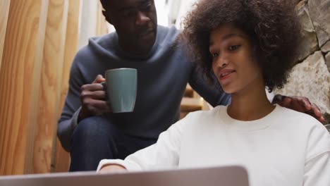 african man and mixed race woman on computer