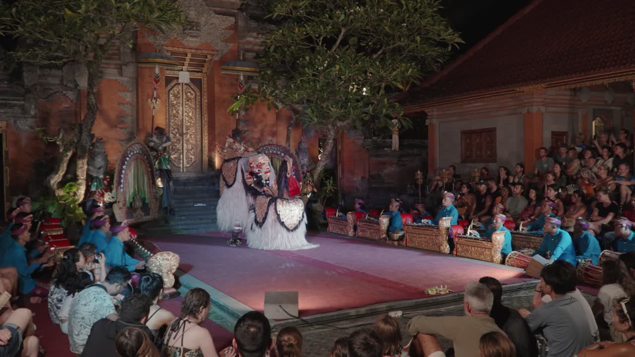 People Watching Traditional Barong Dance Performance at Ubud Palace Bali, Indonesia - wide angle, slow motion