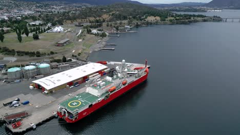 rsv nuyina australia icebreaker at port bridge drone aerial tilt up 50fps