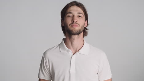 caucasian man in front of camera on gray background.