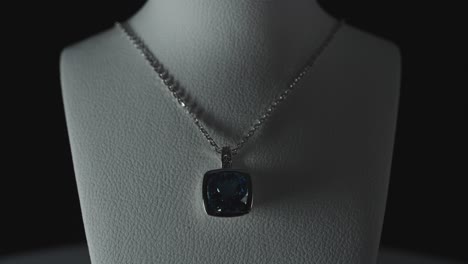 blue gemstone on a necklace on a bust