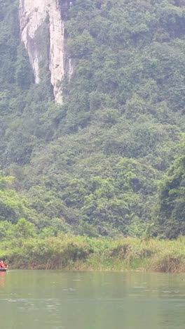 kayakers navigate tranquil waters amidst lush mountains