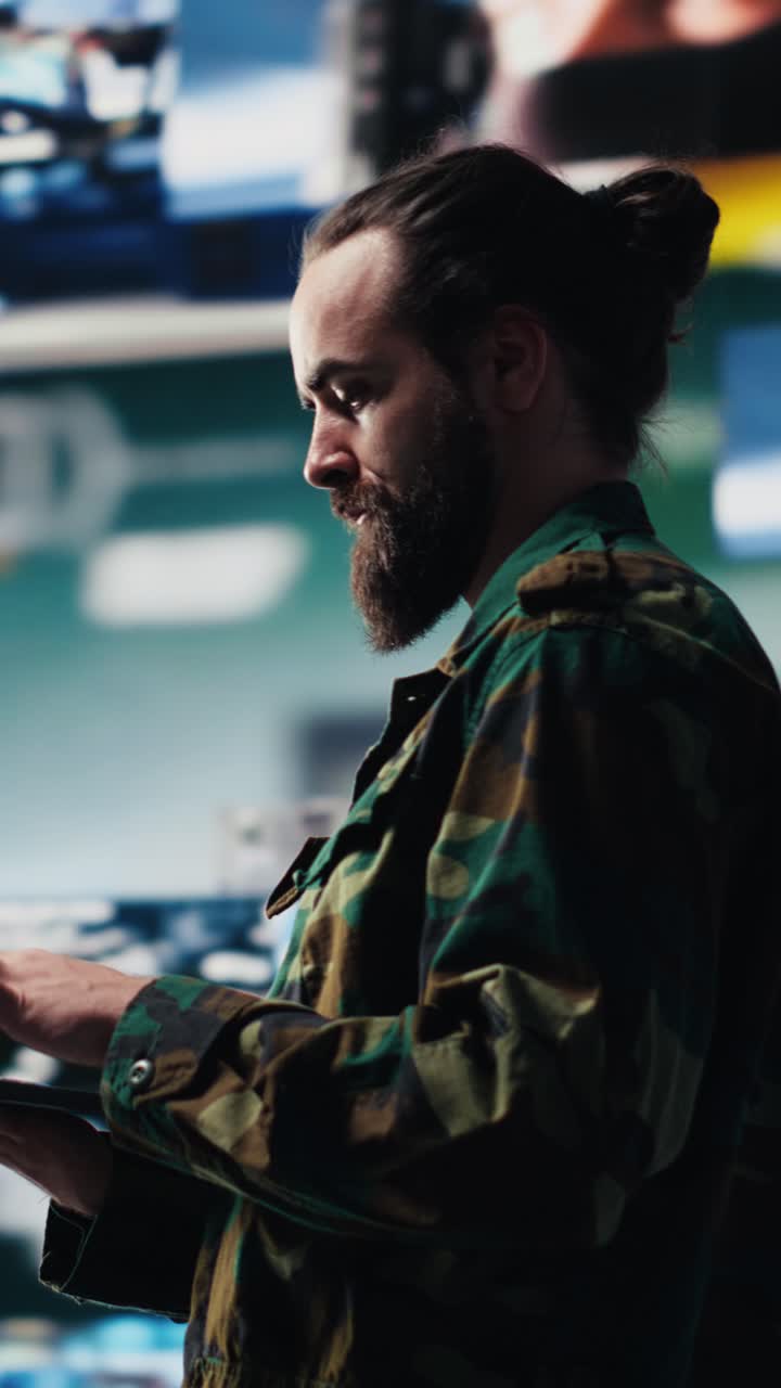 Vertical Video Military officer reviews data from surveillance and works on tactical operations