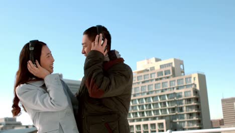 Couple-in-warm-clothes-enjoying-music-together