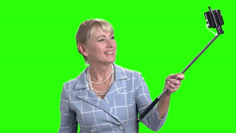 smiling mature woman taking a selfie.