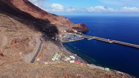 el hierro port, curved mountain road lead to blue ocean marina in canary isles