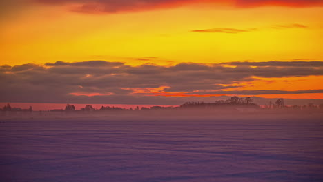 time-lapse morning mist and clouds moving in snowy winter rural riga, latvia