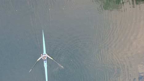 person rowing in shell during calm workout