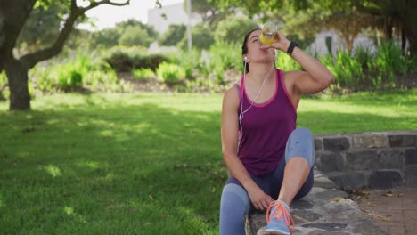 Caucasian-woman-drinking-water-in-a-park