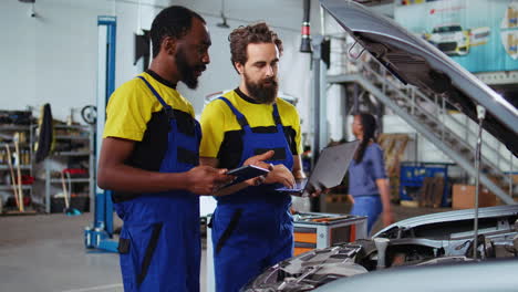 employees working together to fix car