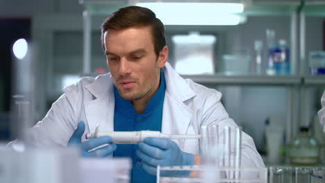 researcher in lab. scientist man with pipette in lab. scientist student