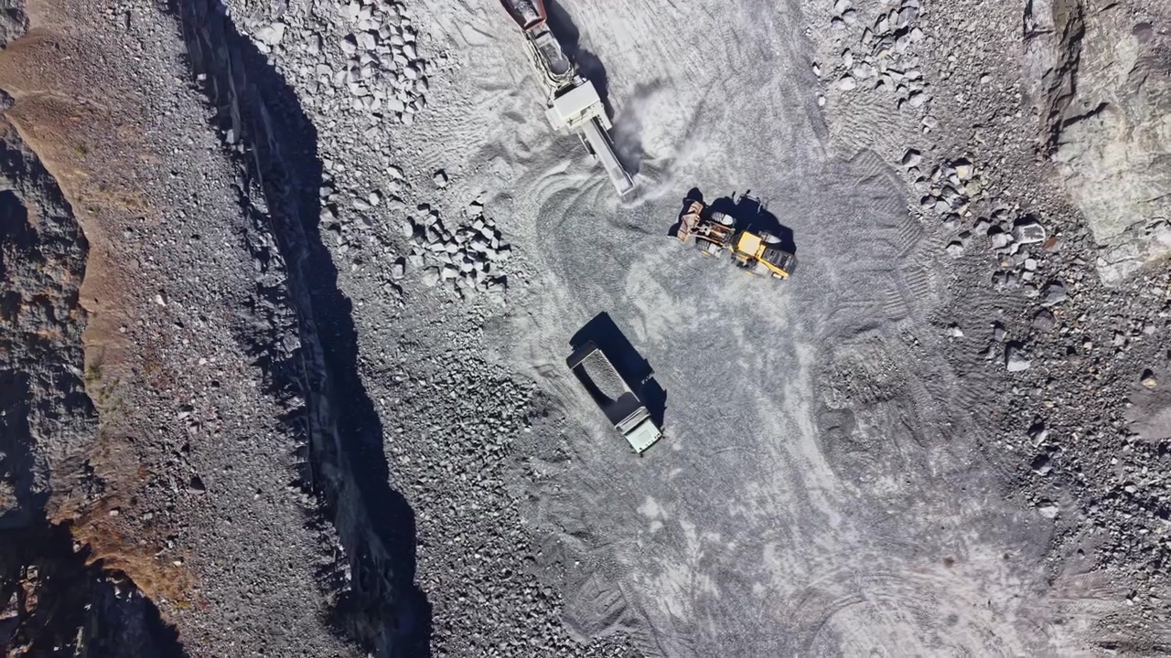 Granite quarry operation showing machinery and materials in action during daytime