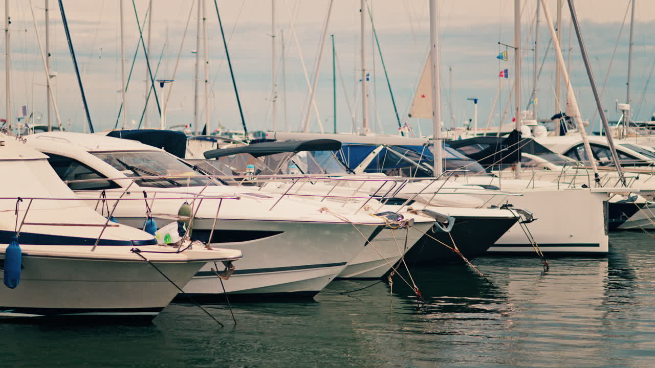 View of white boats docked in the harbour of Golfe-Juan, France on a cloudy day