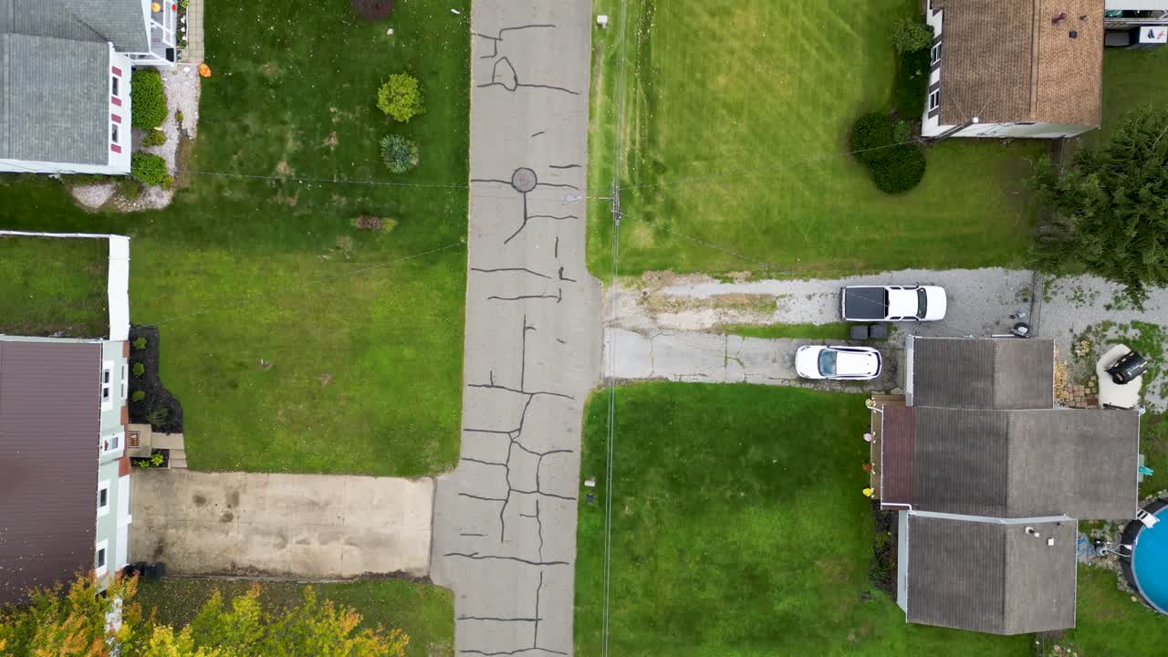 Aerial View of a Residential Neighborhood with Cracked Pavement