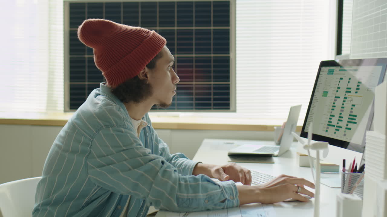 Renewable Energy Developer Using Tablet and Computer at Work
