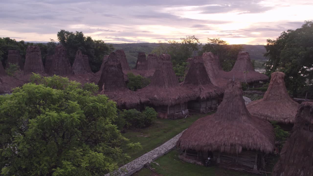 Aerial shot of local village at Sumba with authentic roofs with colourful sky