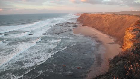 fotografía de mano de la puesta de sol en los acantilados portugueses del atlántico