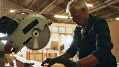carpenter using circular saw in workshop