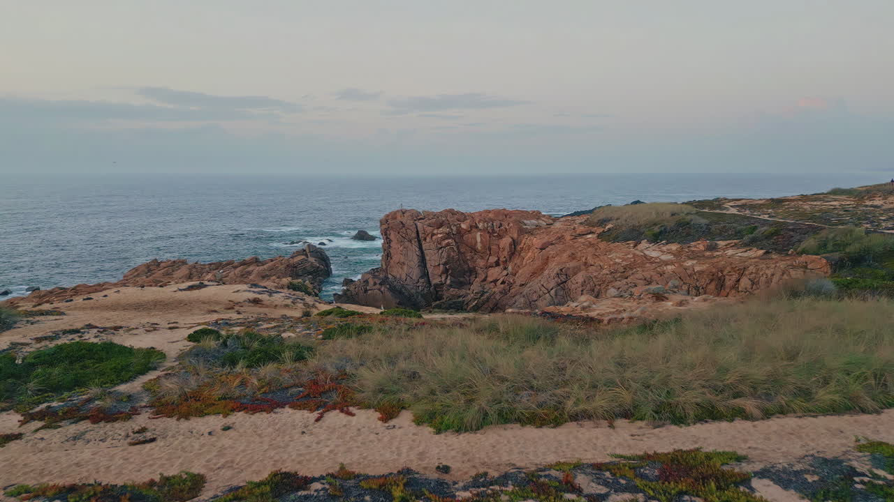 Aerial panoramic rocky cape on dawn. Drone flying over  ocean cliffs