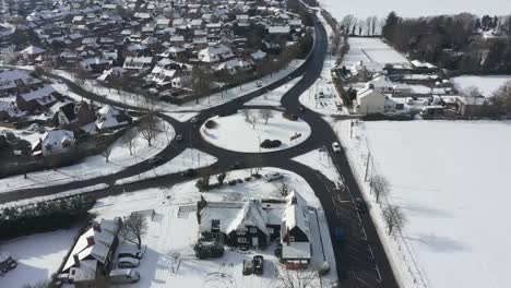 Aerial-pivot-above-snow-covered-roundabout