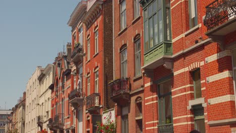 red brick walls facade with balcony on the street of brussels, belgium