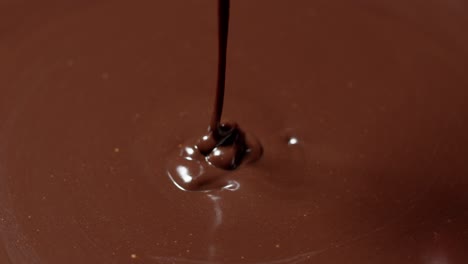 Mixing,-stirring-melted-liquid-dark-chocolate-with-whisk,-confectioner-prepares-dessert,-topping