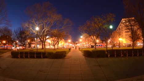 Wide-motion-time-lapse-of-people-walking-during-rush-hour-traffic-at-dusk-in-Dupont-Circle-in-Washington-DC