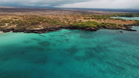 turquoise water of the ocean at hapuna beach in hawaii - aerial drone shot